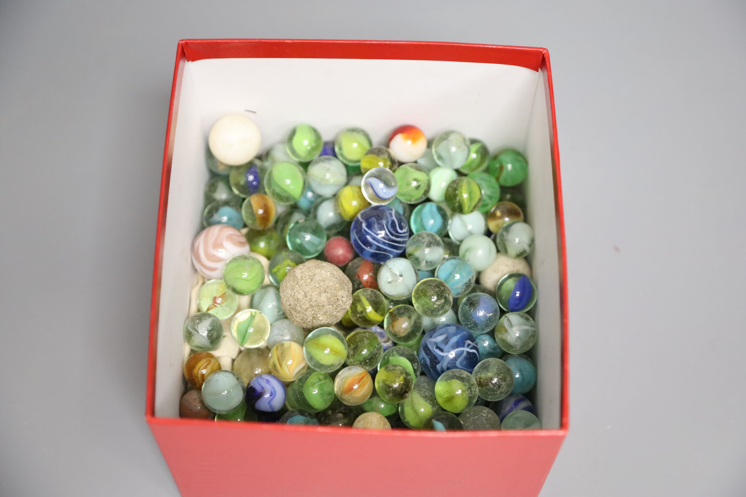 A quantity of marbles, boxwood chess pieces, a solitaire board and bone scrabble pieces and counters